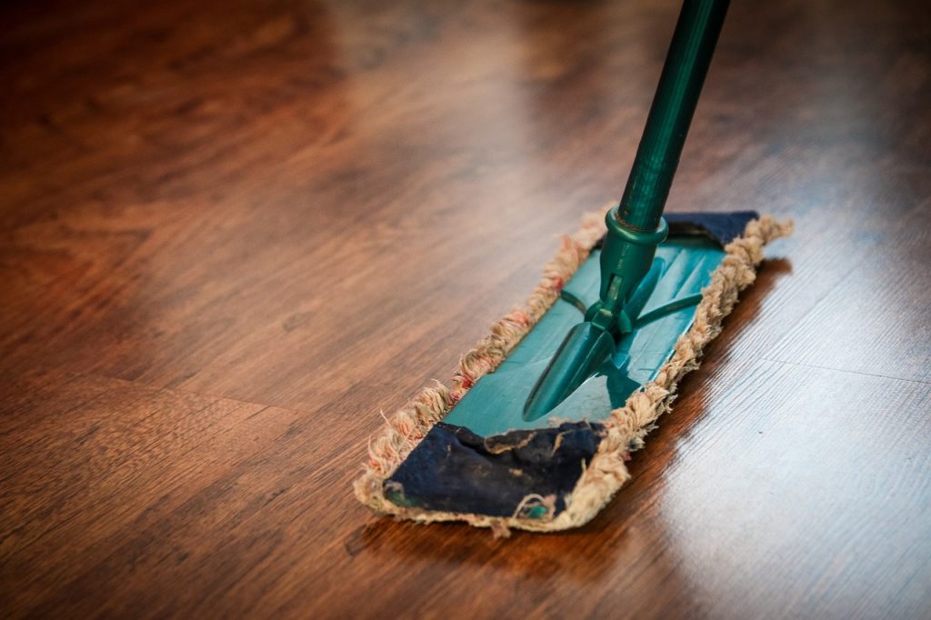 Microfiber mop on wood surface for hardwood floor care tips