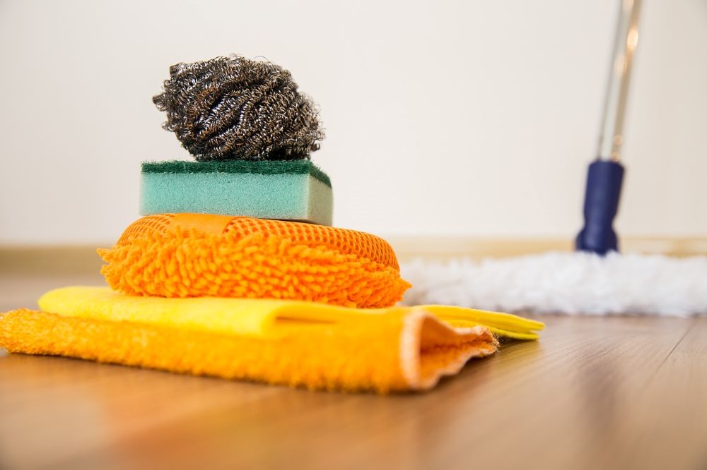 Non-toxic floor cleaning products with microfiber towels on a clean surface