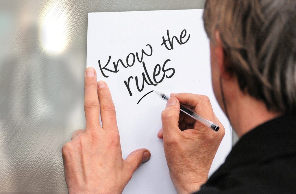 Person writing “Know the Rules” as a reminder for daily floor care habits