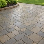 Freshly sealed patio pavers with a smooth wet-look finish.